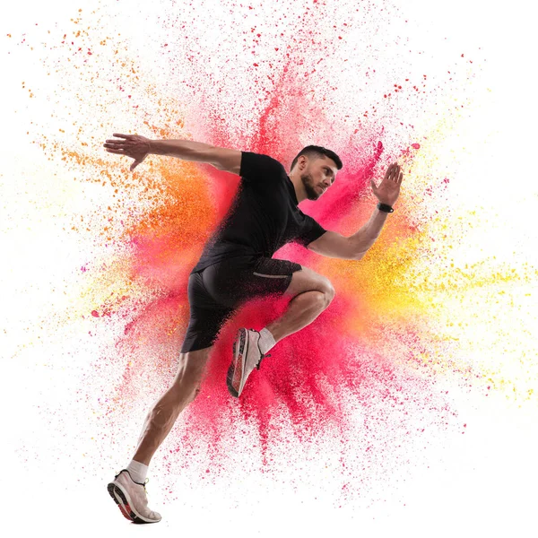 One Caucasian sportsman in explosion of colored neon powder isolated on white background