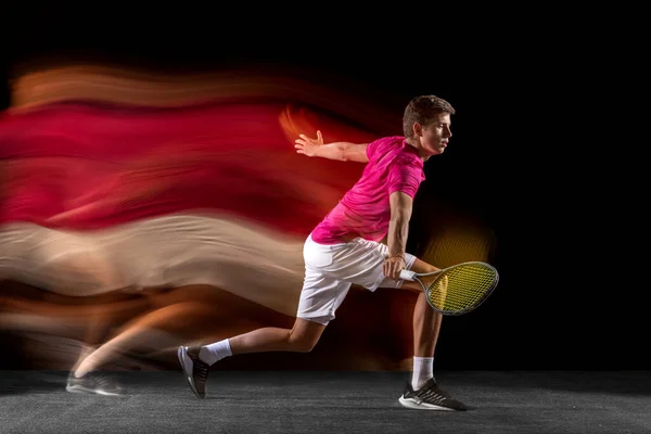 One man, male tennis player training isolated in mixed neon light on dark background. Concept of sport, team competition. — Φωτογραφία Αρχείου