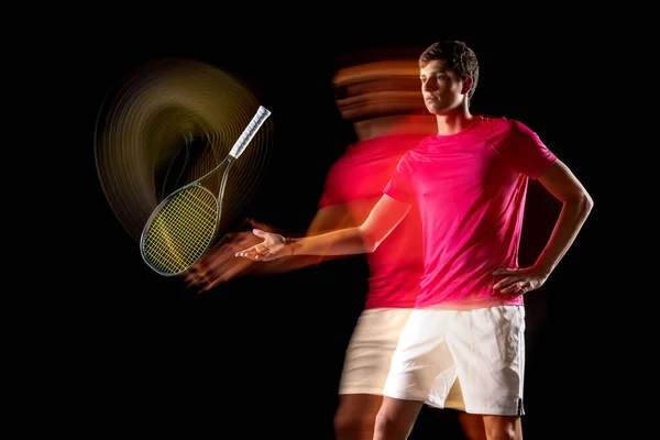 One man, male tennis player training isolated in mixed neon light on dark background. Concept of sport, team competition. — Φωτογραφία Αρχείου