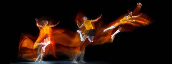 Development of motions. Young girl, volleyball player in action isolated over dark background in neon mixed colored light. Flyer. — 图库照片