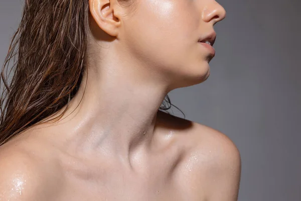 Cropped portrait of young sensual beautiful girl posing isolated on grey studio background. Concept of beauty, cosmetics, spa. — Fotografia de Stock