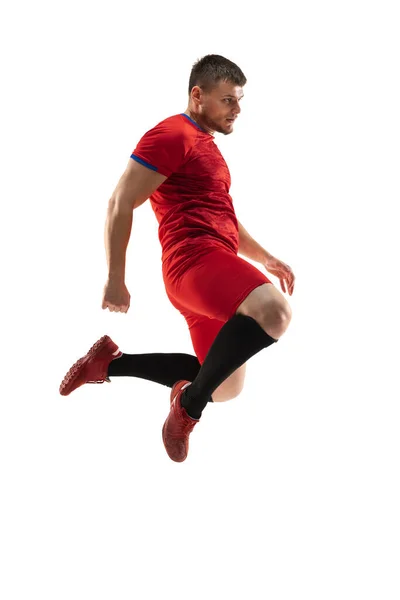 Erős, repül a mező felett. Fiatal futball, focista akcióban, mozgás elszigetelt fehér háttér . — Stock Fotó