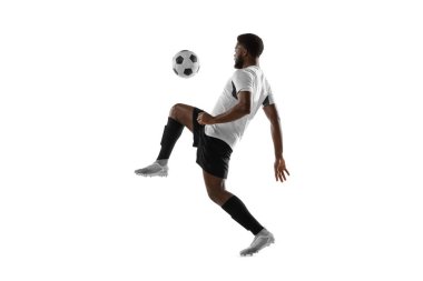 Beyaz arka planda izole edilmiş bir Afrikalı futbolcu eğitimi. Spor, hareket, enerji ve dinamik kavramı.