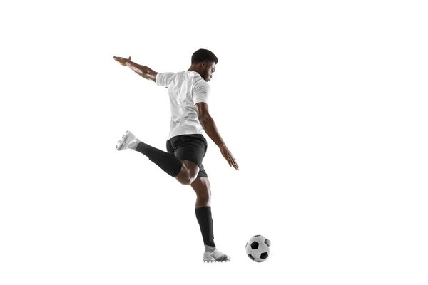 Un jugador de fútbol africano entrenando aislado sobre fondo blanco. Concepto de deporte, movimiento, energía y dinámica. —  Fotos de Stock