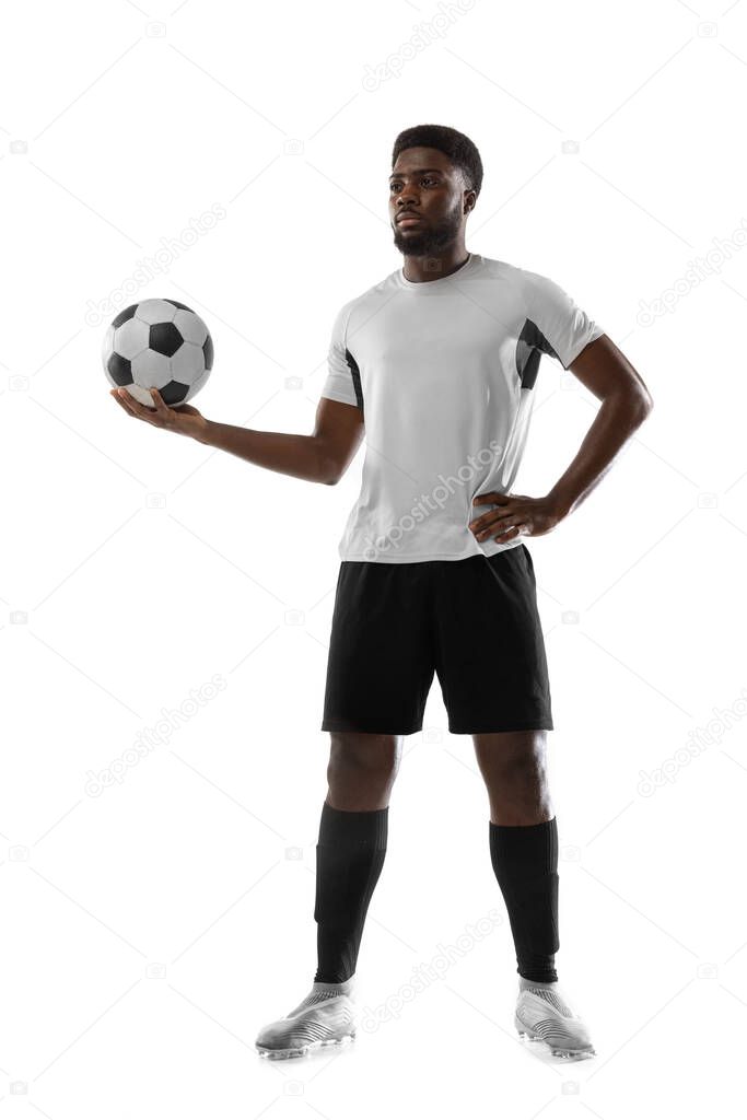 Portrait of young African soccer player posing isolated on white background. Concept of sport.
