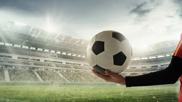 Female hands with soccer, football ball isolated over stadium before sport match on cloudy sky background. Collage. Concept of sport, competition — Stok Foto