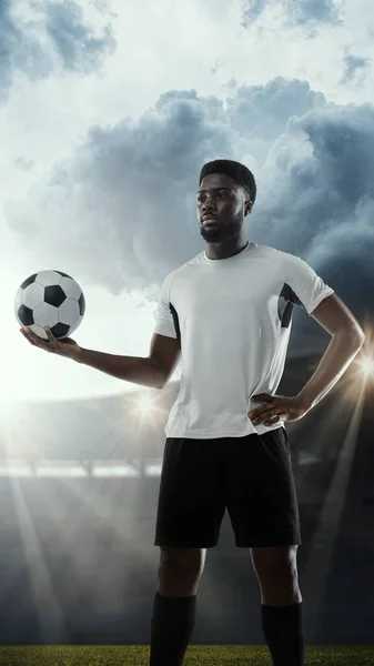 Calcio professionistico maschile, calciatore isolato sullo sfondo dello stadio. Atleta africano in forma prepararsi per la partita — Foto Stock
