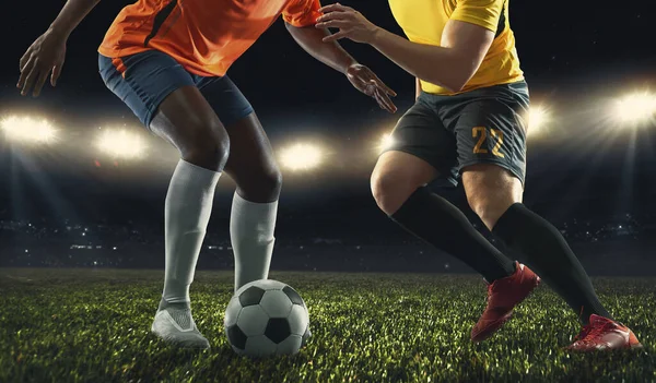 Two male soccer, football players playing at the stadium during sport match on dark sky background. — Stock Photo, Image