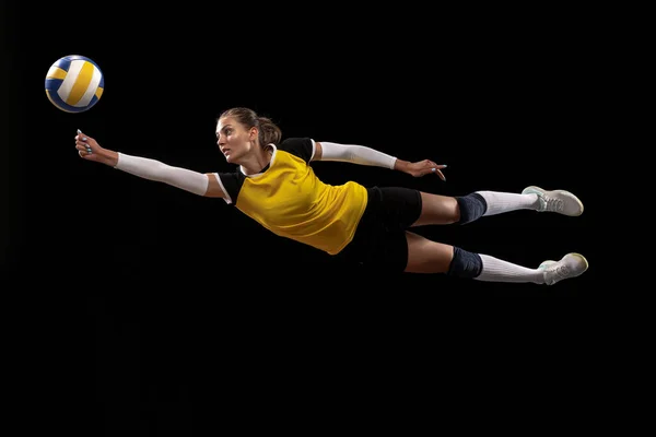 Female professional volleyball player with ball isolated on black studio background. The athlete, exercise, action, sport, healthy lifestyle, training, fitness concept. — Stock Photo, Image