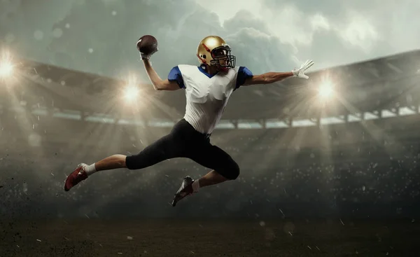 Young man american football player at stadium in motion. Action, activity, sportlife concept. Flyer for ad, design. — Stock Photo, Image