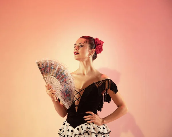 Flamenco dancer Spain woman gypsy with red rose and spanish hand fan