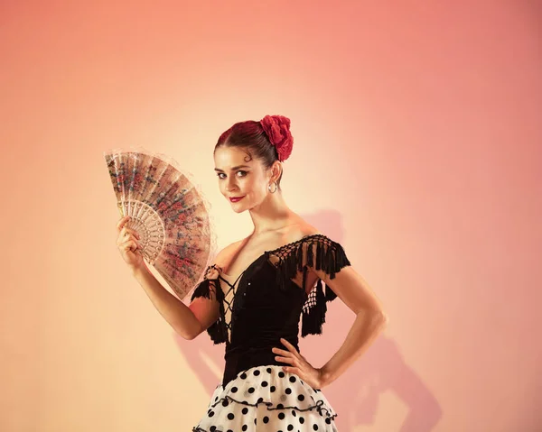 Flamenco dancer Spain woman gypsy with red rose and spanish hand fan