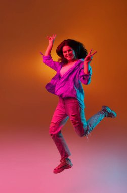 Kafkas genç kadın portresi neon renkli karanlık stüdyo arka planında. İnsan duyguları kavramı, yüz ifadesi.