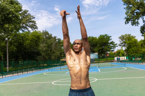Stark muskulös afrikansk-amerikansk manliga basketspelare utbildning på gatan offentliga stadion, idrottsplan eller palyground utomhus. Begreppet hälsosam aktiv livsstil, rörelse, hobby. — Stockfoto