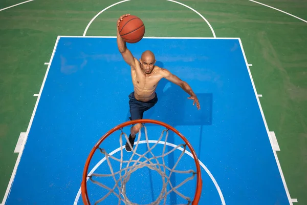 Vista de alto ângulo do jovem, jogador de basquete masculino jogando basquete no estádio público de rua, quadra esportiva ou palyground ao ar livre. Jogos de esporte de verão. — Fotografia de Stock