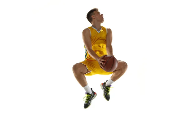 Full length portrait of a basketball player with a ball isolated on white studio background. Advertising concept. Fit Caucasian athlete jumping with ball. — Stock Photo, Image