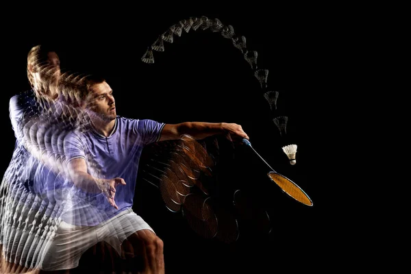 One young male badminton player, shuttler training isolated on dark background. Stroboscope effect. — Foto de Stock