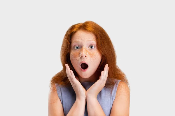 Portrait of cute freckled red-headed girl in casual outfit posing isolated on white studio background. Happy childhood concept. Sunny child — Stock Fotó