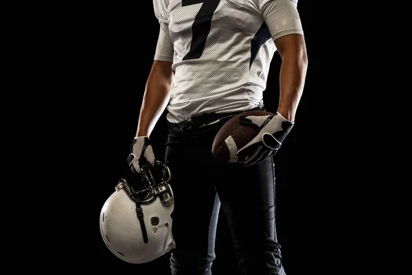 Cropped image of male American football player, athlete posing isolated on black studio background. Concept of professional sport, championship, competition. — стоковое фото