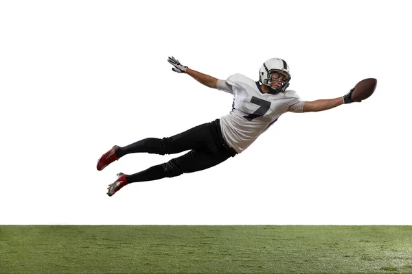 Portrait of American football player catching ball in jump isolated on white studio background. — Stock fotografie
