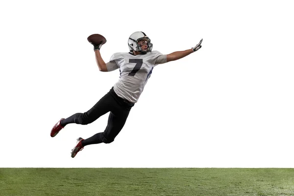 Portrait of American football player catching ball in jump isolated on white studio background. — Stock fotografie