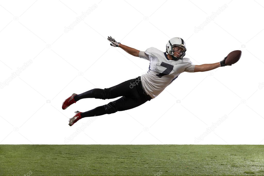 Portrait of American football player catching ball in jump isolated on white studio background.