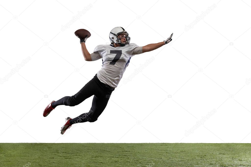 Portrait of American football player catching ball in jump isolated on white studio background.