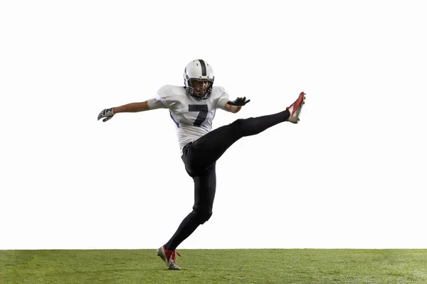 Portrait of American football player training isolated on white studio background with grass covering — Stock Photo, Image