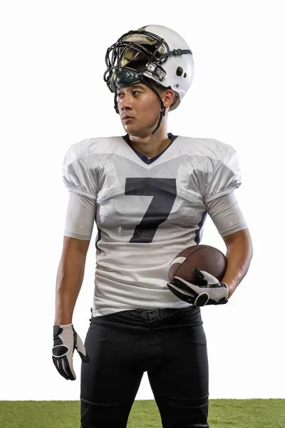 Portrait of young American football player, athlete in sports equipment standing isolated on white studio background. Concept of professional sport, championship, competition. — Foto de Stock