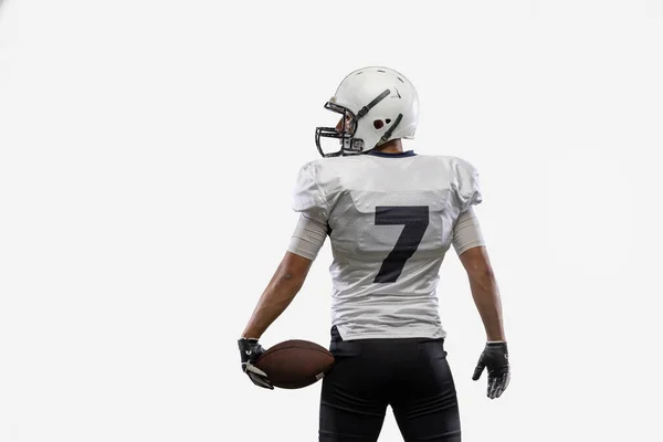 Close-up American football player with ball isolated on white studio background. Back view — стоковое фото