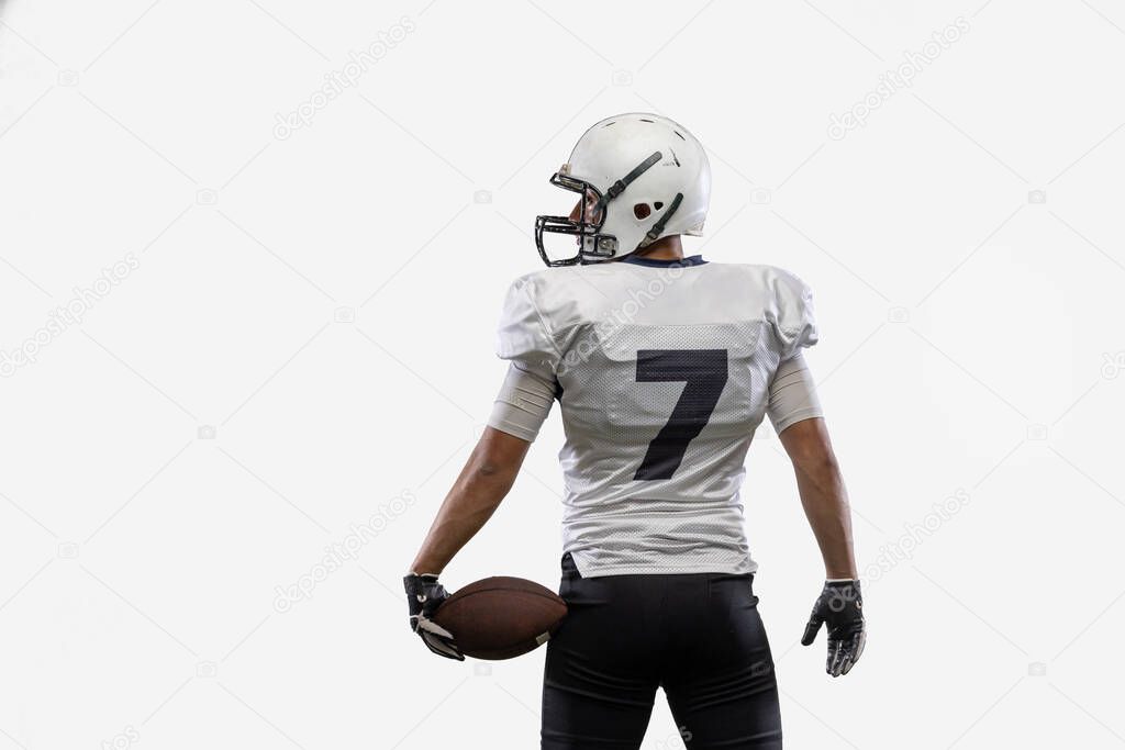 Close-up American football player with ball isolated on white studio background. Back view