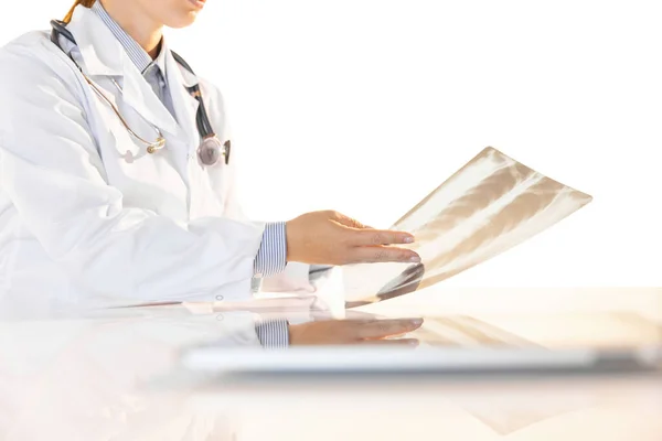 Cropped portrait of doctor, therapeutic or medical adviser looking at x-ray result at work. Concept of healthcare, care and medicine. — Stock Photo, Image