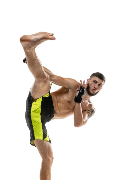 Professional male MMA boxer in motion isolated on white studio background. Fit muscular caucasian athlete fighting. — Stock Photo, Image