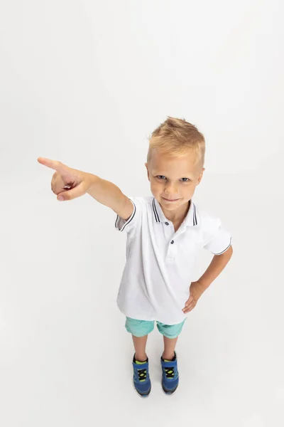High angle view of Caucasian preschool boy isolated on white studio background. Copyspace for ad. Childhood, education, emotion concept — Stockfoto