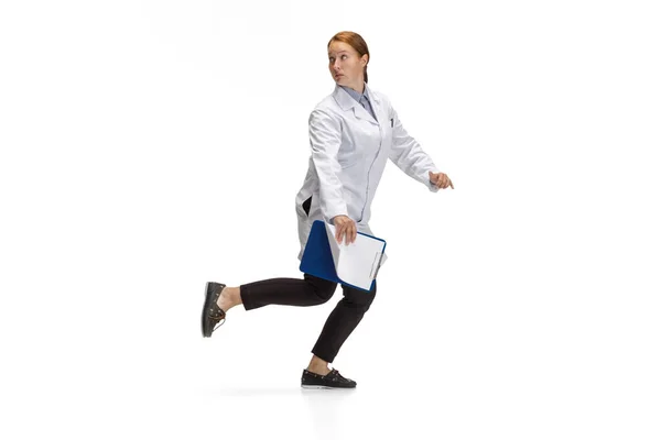 Portrait of running doctor, therapeutic or medical advisor in action and motion isolated on white background. Concept of healthcare, care, medicine — ストック写真