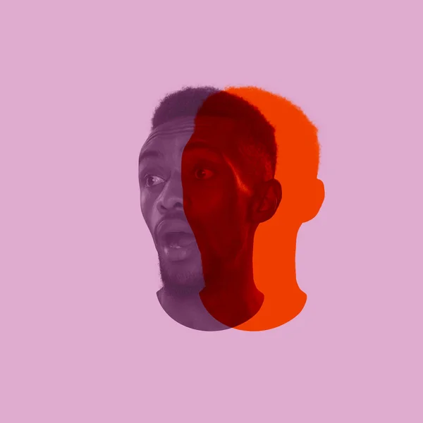 Close-up jovem cara de homem Africano, cabeça com silhueta colorida, sombra isolada no fundo de luz. Emoção humana, personalidade dividida, conceito de problemas mentais. — Fotografia de Stock