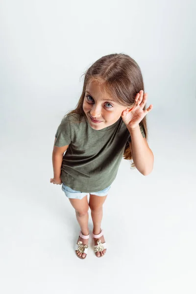 High angle view of Caucasian preschool smiling girl isolated on white studio background. Copyspace for ad. Childhood, education, emotion concept — 图库照片