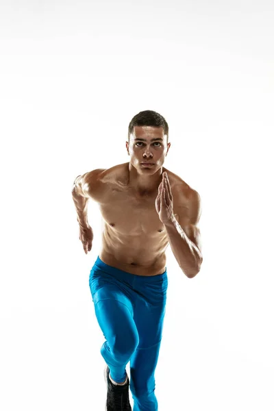 Vista frontal do atleta masculino profissional caucasiano, treinamento de corredor isolado em fundo de estúdio branco. Homem musculoso e desportivo. Conceito de esporte, estilo de vida saudável — Fotografia de Stock