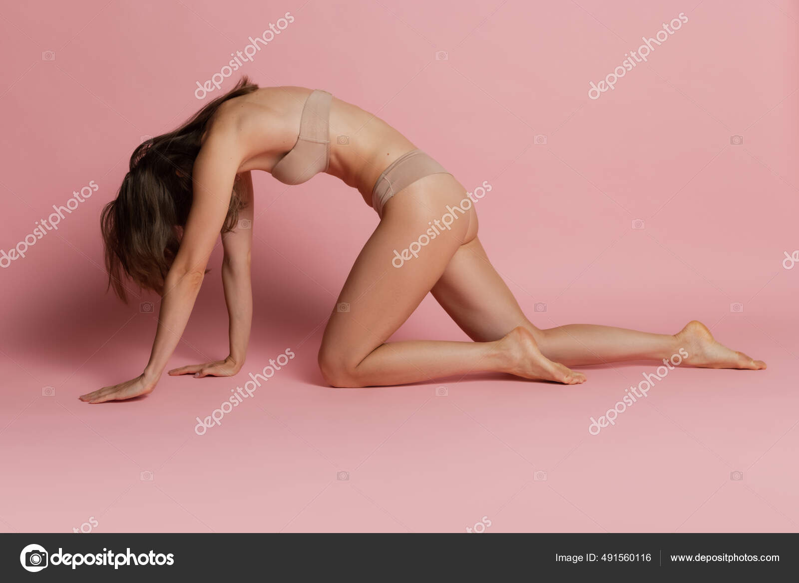 Portrait of young beautiful tanned woman in lingerie posing isolated over  pink studio background. Natural beauty concept. Stock Photo by  ©vova130555@gmail.com 491560116