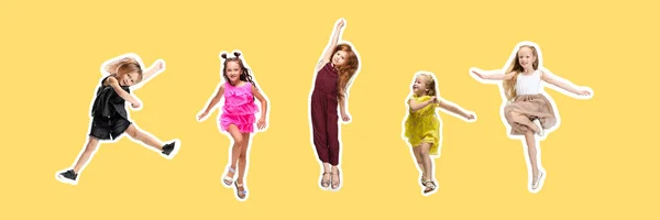 Grupa dzieci szkoły podstawowej lub uczniów skaczących w kolorowe ubrania casual na żółtym tle. Kolaż. — Zdjęcie stockowe