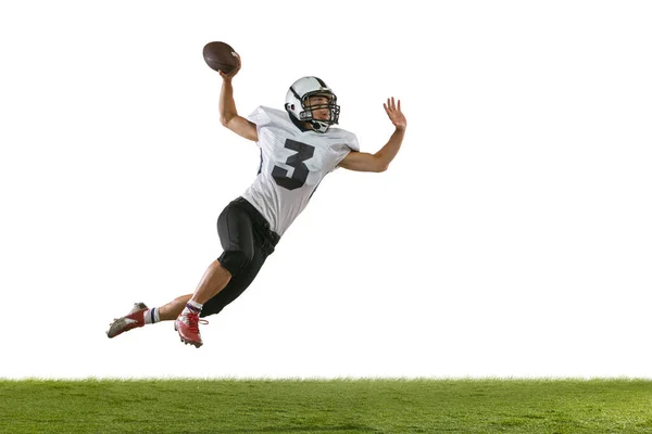 Portrait of American football player training isolated on white studio background with green grass. Concept of sport, competition — Stock Photo, Image