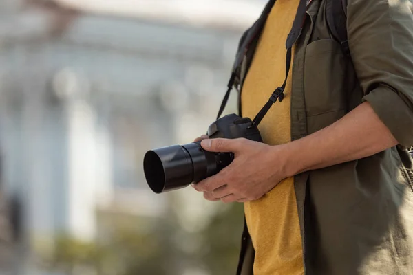 Image recadrée de l'homme, photographe, caméraman avec appareil photo professionnel, équipement pendant la journée de travail d'été à l'extérieur. Notion de profession, d'emploi, d'éducation — Photo