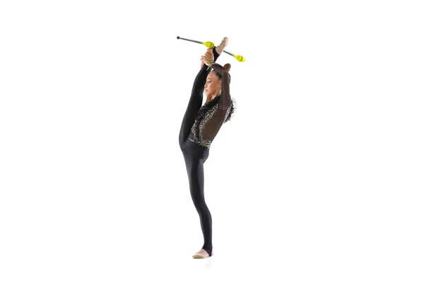 One Caucasian girl, rhythmic gymnastics artist practicing with baton isolated on white studio background. Concept of sport, action, aspiration, education, active lifestyle — Stock Photo, Image