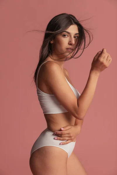 Close-up portrait of young beautiful arabian woman without makeup isolated over pink studio background. Natural beauty concept. — Stock Photo, Image