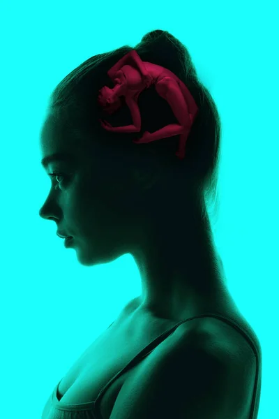 Conceptual image with silhouette of young girl and pictures in her head with secrets of subconsciousness, human microcosm. Artwork.