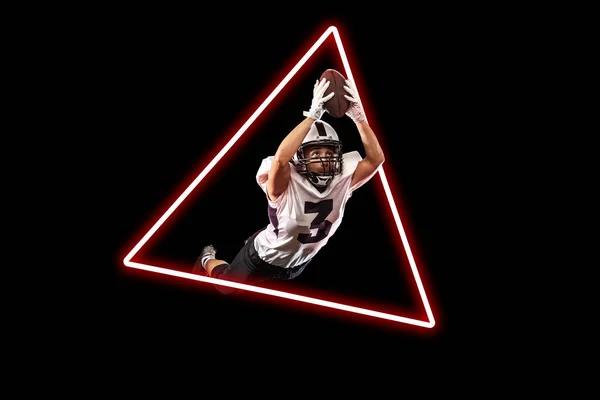 Art collage, concept of sport, action, motion in sport. Young american football player flying through luminescent triangle on black background — Stock Photo, Image