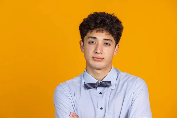 Half-length portrait of young curly man isolated over yellow studio background with copyspace for ad. Concept of human emotions, fashion, beauty, youth — Stock Photo, Image