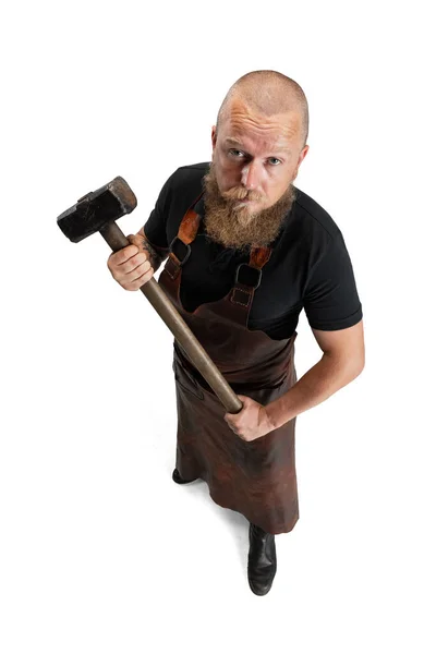 High angle view of bearded bald man, blacksmith wearing leather apron or uniform isolated on white studio background. Concept of labor, retro professions, power, beauty, humor — Stock Photo, Image