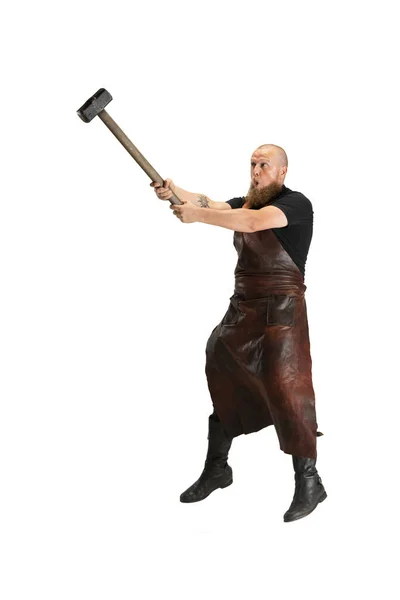 One muscular bearded bald man, blacksmith wearing leather apron or uniform isolated on white studio background. Concept of labor, retro professions, power, beauty, humor — Stock Photo, Image