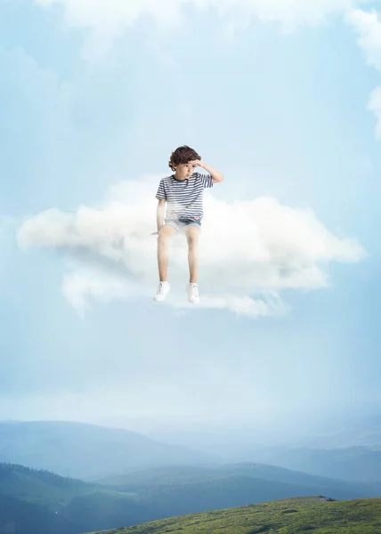 Creative collage with little preschool boy sitting on white cloud and flying at sky, outdoors. Concept of childhood, happiness, dreams, adventure — Stock Photo, Image